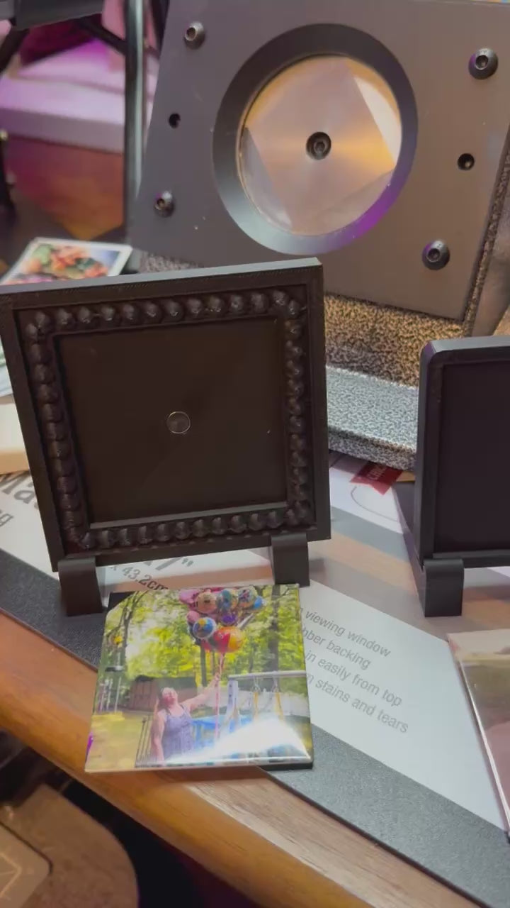 Photo frame holds round photo magnet